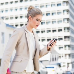 businesswoman-walking-with-smartphone-web